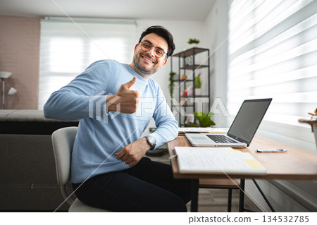 Man Sitting at Desk Giving Thumbs Up Man Sitting at Desk Giving Thumbs Up 134532785