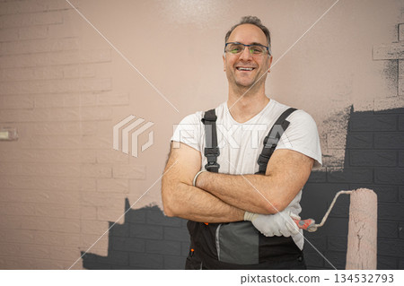 Man Standing in Front of Wall With Arms Crossed 134532793