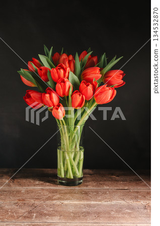 Spring flowers in a vase. A bouquet of fresh red tulips, birthday or easter background Spring flowers in a vase. A bouquet of fresh red tulips, birthday or easter background 134532870