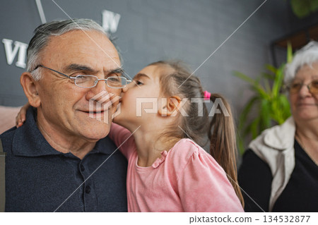 Sweet moment between grandpa and granddaughter 134532877