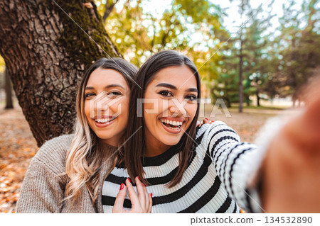 Joyful moments between friends celebrating love in autumn's embrace Joyful moments between friends celebrating love in autumn's embrace 134532890
