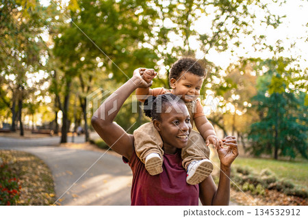 Joyful moments of a mother and child in a sunny park 134532912