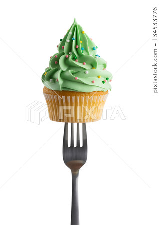 Delicious cupcake with vibrant green frosting and colorful sprinkles speared on a fork, against transparent background Delicious cupcake with vibrant green frosting and colorful sprinkles speared on a fork, against transparent background 134533776