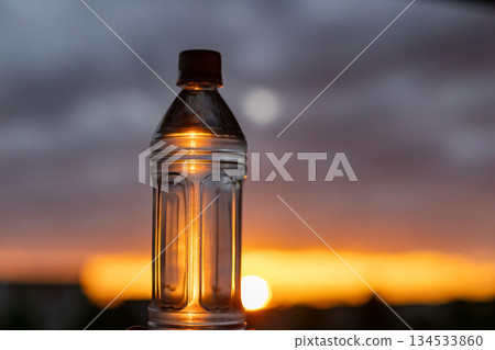 Plastic bottles and water shining in the setting sun | Vertical Plastic bottles and water shining in the setting sun | Vertical 134533860