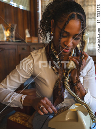 Young Woman Using Vintage Phone 134533878