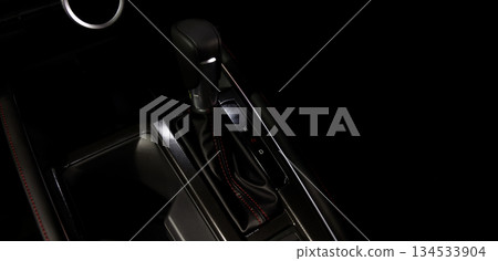 Car gear. Close up of modern car automatic gear selector or electronic shifter. Premium interior design EV car gears driving control. auto transmission modes. Automotive technology in motion driving. Car gear. Close up of modern car automatic gear selector or electronic shifter. Premium interior design EV car gears driving control. auto transmission modes. Automotive technology in motion driving. 134533904