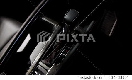 Car gear. Close up of modern car automatic gear selector or electronic shifter. Premium interior design EV car gears driving control. auto transmission modes. Automotive technology in motion driving. Car gear. Close up of modern car automatic gear selector or electronic shifter. Premium interior design EV car gears driving control. auto transmission modes. Automotive technology in motion driving. 134533905
