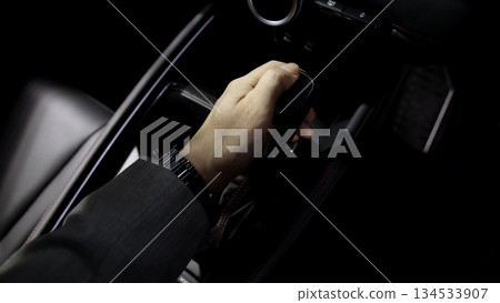 Car gear. Close up of modern car automatic gear selector or electronic shifter. Premium interior design EV car gears driving control. auto transmission modes. Automotive technology in motion driving. Car gear. Close up of modern car automatic gear selector or electronic shifter. Premium interior design EV car gears driving control. auto transmission modes. Automotive technology in motion driving. 134533907