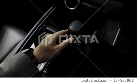 Car gear. Close up of modern car automatic gear selector or electronic shifter. Premium interior design EV car gears driving control. auto transmission modes. Automotive technology in motion driving. 134533908
