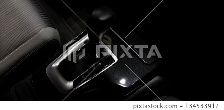 Car gear. Close up of modern car automatic gear selector or electronic shifter. Premium interior design EV car gears driving control. auto transmission modes. Automotive technology in motion driving. Car gear. Close up of modern car automatic gear selector or electronic shifter. Premium interior design EV car gears driving control. auto transmission modes. Automotive technology in motion driving. 134533912