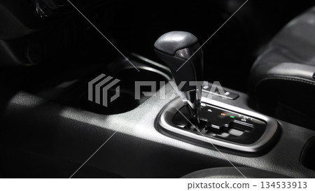 Car gear. Close up of modern car automatic gear selector or electronic shifter. Premium interior design EV car gears driving control. auto transmission modes. Automotive technology in motion driving. 134533913