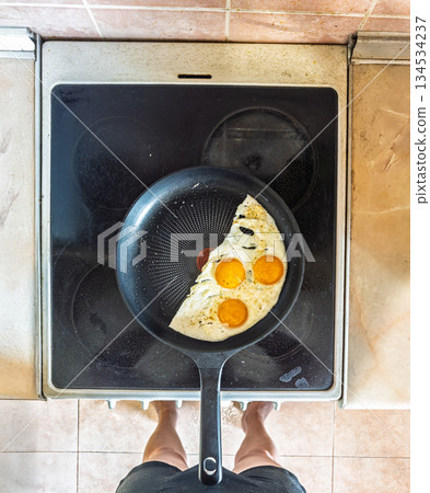 Steel skillet holding three bright eggs representing dawn is promise resilience 134534237