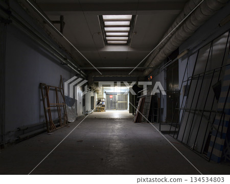 Long dark corridor in an old industrial building 134534803