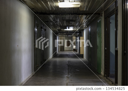 Long dark corridor in an old industrial building 134534825