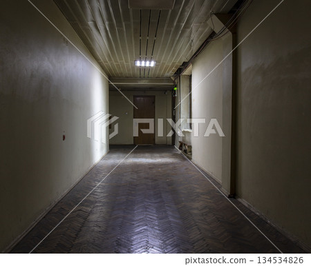 Long dark corridor in an old industrial building Long dark corridor in an old industrial building 134534826