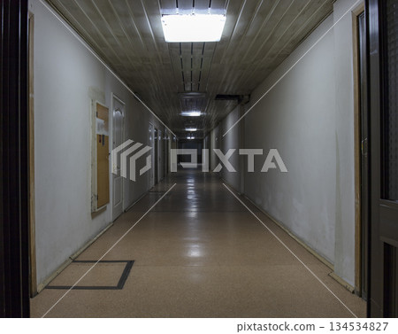 Long dark corridor in an old industrial building Long dark corridor in an old industrial building 134534827