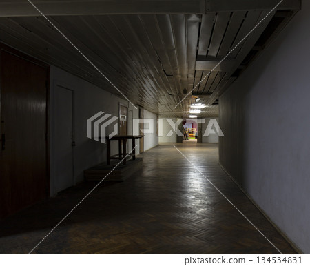 Long dark corridor in an old industrial building 134534831
