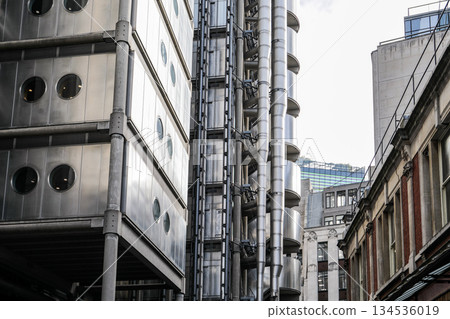 Modern Industrial Architecture with Exposed Steel Pipes and Urban Buildings Modern Industrial Architecture with Exposed Steel Pipes and Urban Buildings 134536019