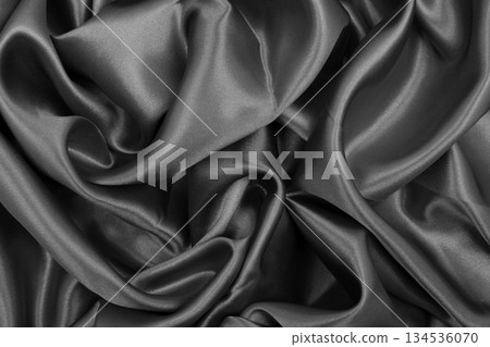Smooth elegant dark grey silk or satin texture can use as abstract background. Luxurious background design Smooth elegant dark grey silk or satin texture can use as abstract background. Luxurious background design 134536070