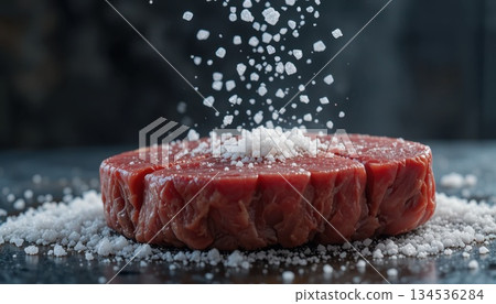 Beef Cut Sprinkled With Salt on a Dark Surface During Preparation in a Kitchen Setting Beef Cut Sprinkled With Salt on a Dark Surface During Preparation in a Kitchen Setting 134536284