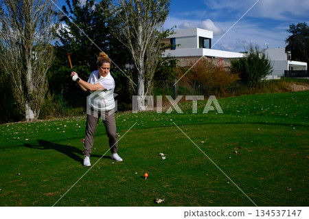 woman playing golf in the green fairway club 134537147