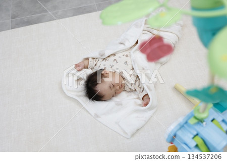 A cute sleeping face of a 10-month-old baby girl taking a nap. A cute sleeping face of a 10-month-old baby girl taking a nap. 134537206