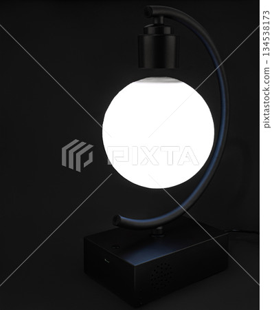 levitating ball lamp, on black background levitating ball lamp, on black background 134538173