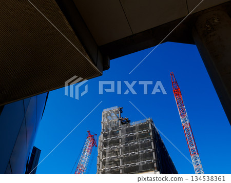 A construction site where buildings are being constructed under the blue sky 134538361