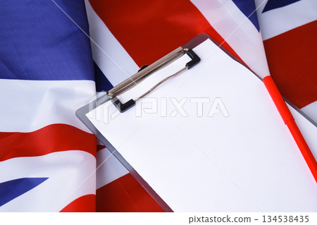 Empty white paper frame National symbol of Great Britain. Mock up advertisement template UK British wave fabric flag background. Copy space for your text. Independence Empty white paper frame National symbol of Great Britain. Mock up advertisement template UK British wave fabric flag background. Copy space for your text. Independence 134538435