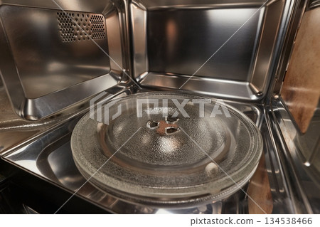 Heating food in a microwave oven, open door Heating food in a microwave oven, open door 134538466
