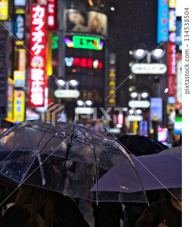 Rainy night in Shinjuku and silhouettes of umbrellas Rainy night in Shinjuku and silhouettes of umbrellas 134538504