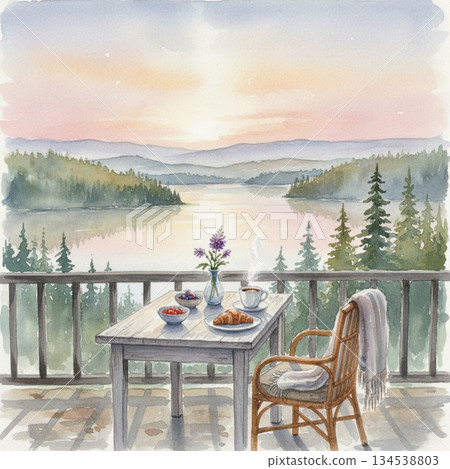Breakfast setup on a wooden table overlooking a tranquil lake, framed by evergreen trees. A steaming cup of coffee, a croissant, and bowls of berries adorn the table, along with a small vase of purple 134538803