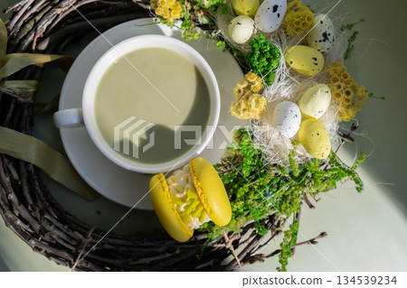 Green latte matcha with yellow macaron dessert and EASTER sustainable decoration. Concept of holiday breakfast morning tea drink. Cozy minimalist superfood vibrant colors healthy eating. Organic Green latte matcha with yellow macaron dessert and EASTER sustainable decoration. Concept of holiday breakfast morning tea drink. Cozy minimalist superfood vibrant colors healthy eating. Organic 134539234