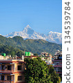 A distant view of the city of Pokhara, Nepal, and Machhapuchhre in the Himalayas A distant view of the city of Pokhara, Nepal, and Machhapuchhre in the Himalayas 134539784