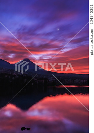 Before dawn, Lake Onneto reflects Mount Akan Fuji and Mount Meakan. 134540391