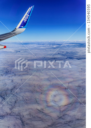 A fantastic sea of clouds and rainbow-colored light seen from an airplane A fantastic sea of clouds and rainbow-colored light seen from an airplane 134540395