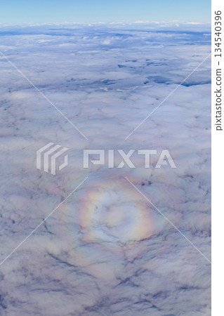 A sea of clouds and a faint ring of light in the sky 134540396