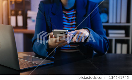 Businesswoman hand using smart phone laptop and tablet with social network 134541745