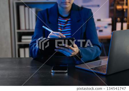 Businesswoman hand using smart phone laptop and tablet with social network Businesswoman hand using smart phone laptop and tablet with social network 134541747