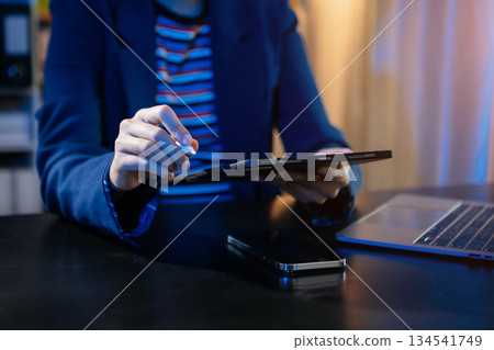 Businesswoman hand using smart phone laptop and tablet with social network Businesswoman hand using smart phone laptop and tablet with social network 134541749