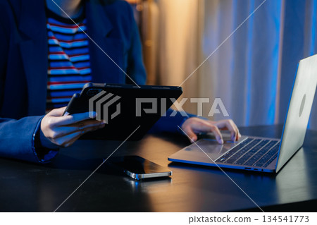 Businesswoman hand using smart phone laptop and tablet with social network 134541773