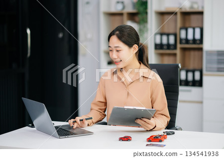 Asian people car salesman or sales manager offers to sell a car and explains of signing a car contract and signing car insurance Asian people car salesman or sales manager offers to sell a car and explains of signing a car contract and signing car insurance 134541938