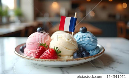A bowl of French ice cream with strawberries and blueberries, featuring the blue, white, and red of the French flag 134541951