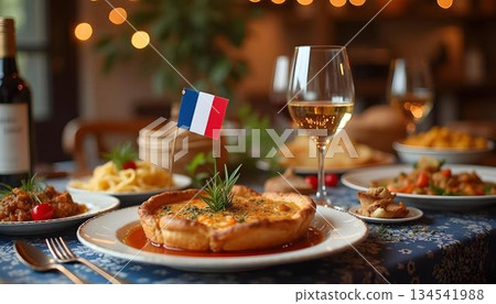 French cuisine and wine arranged on a table, with a French flag in the background 134541988