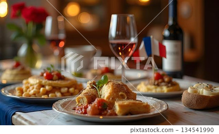 Table set with French dishes and wine, featuring a French flag 134541990