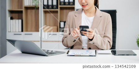 businesswoman hand working with new modern computer using on smartphone and tablet as concept 134542109