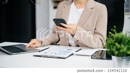 businesswoman hand working with new modern computer using on smartphone and tablet as concept 134542110