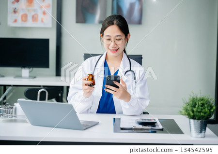 Healthcare costs and fees concept.Hand of smart doctor used a calculator and smartphone, tablet for medical costs at hospital Healthcare costs and fees concept.Hand of smart doctor used a calculator and smartphone, tablet for medical costs at hospital 134542595