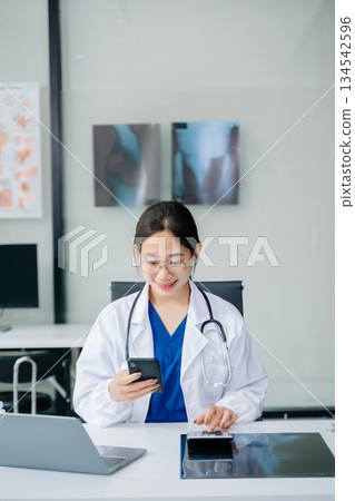Healthcare costs and fees concept.Hand of smart doctor used a calculator and smartphone, tablet for medical costs at hospital Healthcare costs and fees concept.Hand of smart doctor used a calculator and smartphone, tablet for medical costs at hospital 134542596