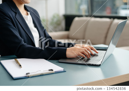 businesswoman hand working with new modern computer using on smartphone and tablet as concept 134542836